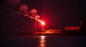 A person holding a flare gun on a boat during an emergency